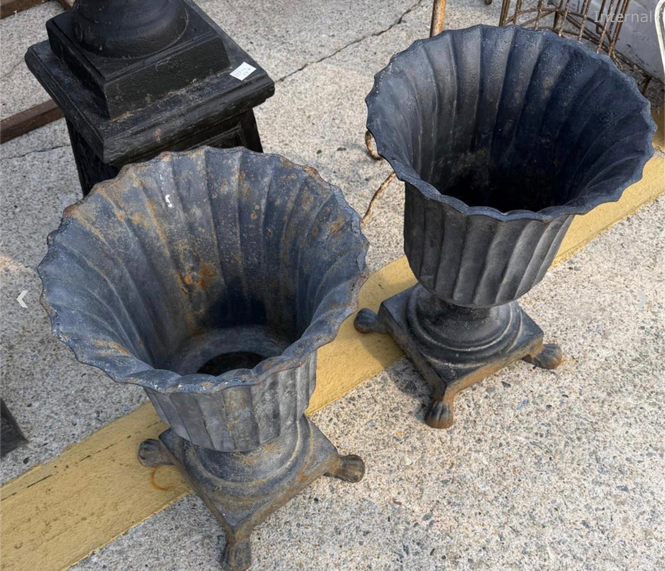 Small Pair of cast iron urns - fluted w/paw feet